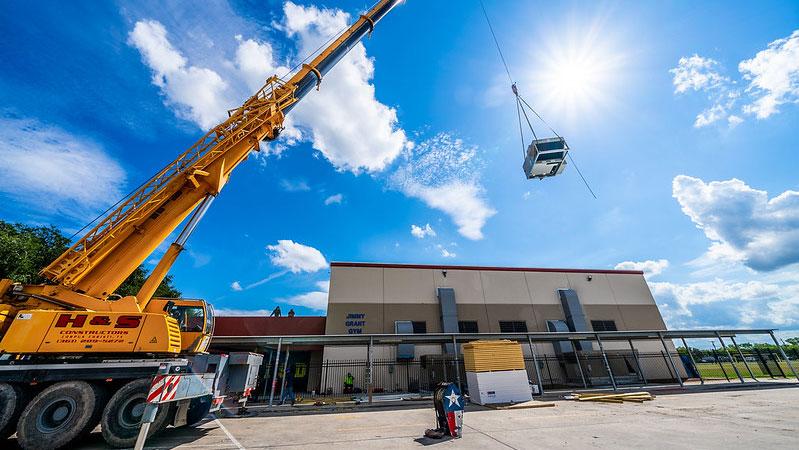 Crane lowering large unit